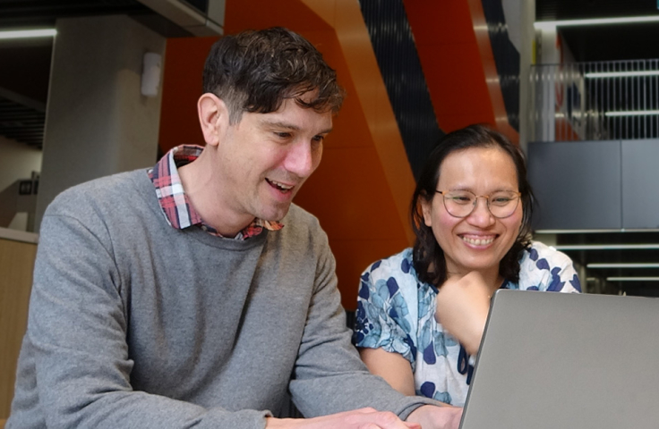 Julian with fellow researcher Preeyaporn Srasubkel working on Julian's laptop